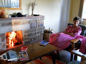 Penny snuggling in a blanket by the fire and reading a great book: Blue Like Jazz