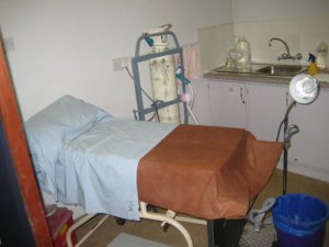 This is the room where VIA is done: The bed with stirrups, a sink, a lamp, a giant bottle of vinegar, and a cryo gun connected to a CO2 cylinder in case they need to do cryotherapy.