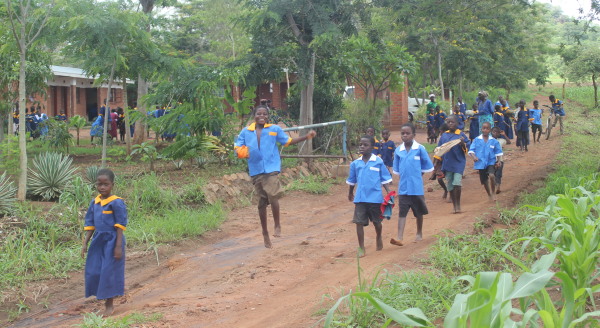 Children returning home from Kindle with their new school uniforms