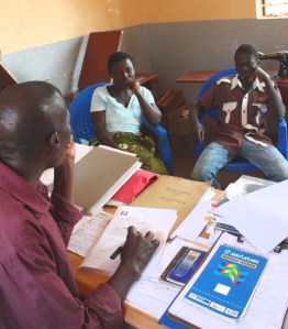Mr. Mbena interviewing potential secondary school students for support by Kindle